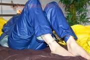 Lucy ties, gagges and hoodes herself on a bed wearing a sexy AGU rainnwear combination (Pics)
