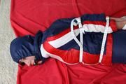Julia tied and gagged in a shiny nylon skisuit