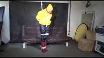 MARA tied and gagged overhead with ropes and a ballgag wearing a super sexy super shiny black rain pants, rubber boots and a yellow down jacket (Video)