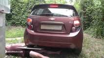 Mistress Jenna stands on the slave with a car while smoking in the slave's mouth B