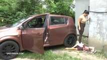 Mistress Jenna stands on the slave with a car while smoking in the slave's mouth B