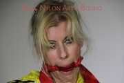 Sexy Lucy tied an gagged with ropes and a cloth gag wearing a super hot red shiny nylon shorts and a yellow rain jacket (Pics)