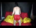 Sexy Mara wearing only a red shiny nylon shorts lolling and posing on the sofa (Video)