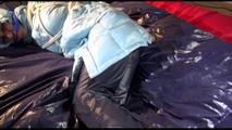Lulu tied and gagged on a bed wearing a sexy blue shiny nylon rainpants and a iceblue PAMY downjacket (Video)