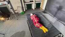 Alice bound and gagged in a nylon Rainsuit