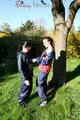 Jill and her friend in the garden playing with eachother wearing sexy shiny nylon rainwear (Pics)