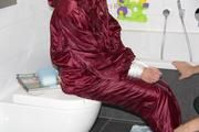 Isabelle tied and gagged in a shiny downwear