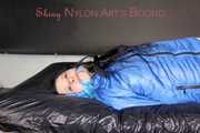 Lucy wearing sexy lightblue downwear tied and gagged with ropes and cloth gag on a bed (Pics)
