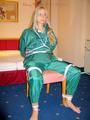 Blonde archive girl tied and gagged in an green shiny nylon rainsuit on a chair (Pics)