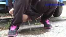 069017 Tiffany Pees Behind A Parked Trailer
