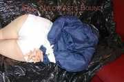 LUCY tied and gagged with ropes and a cloth gag wearing a supersexy white shiny nylon shorts and blue rain jacket (Pics)