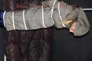 Sexy Sandra being tied and gagged overhead with ropes and a clothgag hodded wearing a sexy rainwear combination (Pics)