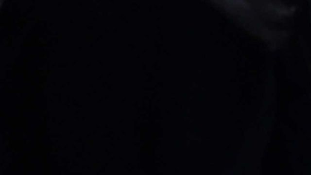 Mistress Tokyo smoking cigarette in leather, gloves and Muir Cap; fetish, POV