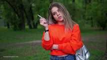 Pretty Kate is smoking Marlboro Red 100s in the park
