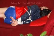 Jill tied and gagged on a sofa wearing a shiny nylon shorts and a rain jacket (Pics)