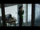 Enni with black shiny nylon shorts and rain pants and a rain jacket over naked skin smoking a cigarette (Video)