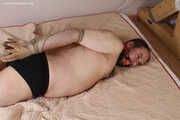 Amanda ties up and gags a man, then spanks and tickles him