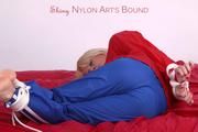 Pia tied and gagged on bed in a shiny bluerainpants and red rainjackert (Pics)