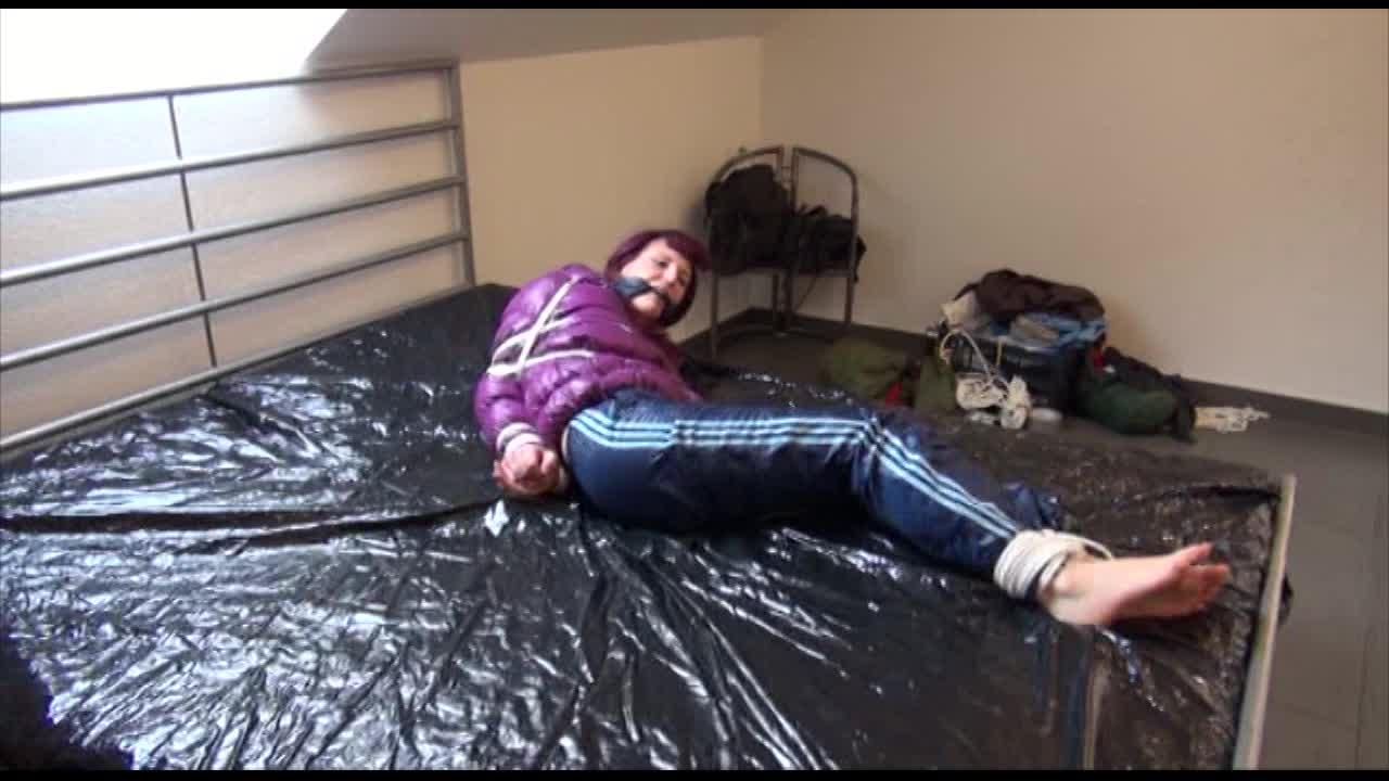 Mara Tied And Gagged On Bed Wearing S Shiny Purple Down Jacket And Blue Rain Pants (Video)