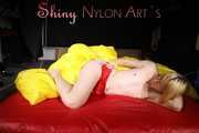 Sexy Sonja posing for you in a red shiny nylon shorts and a tshirts and then she takes it off and plays with the bedding (Pics)