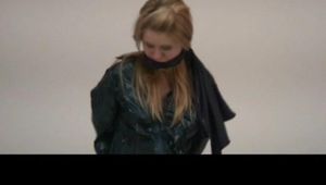 Samantha tied and gagged on a chair with green shiny nylon shorts and a green rain jacket (Video)