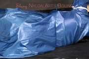 Lucy tied with cuffs overhead and gagged with a clothgag wearing sexy blue rain pants and a raincoat (Pics)