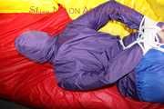 Sonja tied, gagged and hooded with ropes and a cloth gag on the sofa wearing a supersexy blue rain pants and a purple rain jacket (Pics)