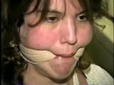 SWEET SHY HEATHER IS MOUTH STUFFED, ACE BANDAGE CLEAVE GAGGED, BAREFOOT, TOES TIED AND BOUND TO A CHAIR (D46-13)