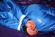 Alina tied and gagged in a shiny skisuit