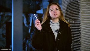Nice girl is smoking all white cigarette 