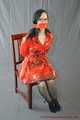 Bound in PVC minidress and red raincoat