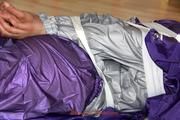 Alina tied, hodded and gagged on the floor in an purple/silver shiny PVC suit (Pics)