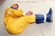 Katharina tied and gagged in a yellow rainsuit