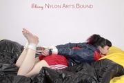 Jill tied and gagged on a bed wearing red shiny nylon shorts(Pics)