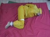 two short videos with our archive girls tid and gagged in shiny nylon rainwear