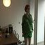 Marlin in the kitchen preparing a coffee wearing a green shiny nylon shorts and a green rain jacket (Video)