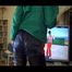 Mara wearing a blue shiny nylon shorts a black leggin and a grren rain jacket during her workout (Video)