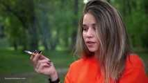 Pretty Kate is smoking Marlboro Red 100s in the park