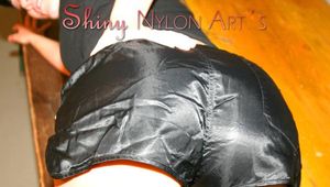 Jill posing in a club wearing a black shiny nylon shorts and a black top (Pics)