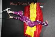 Watching sexy Sonja wearing a supersexy purple shiny nylon rainwear combination being tied and gagged overhead with ropes and a clothgag (Pics)