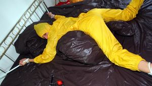 Stella tied and gagged in a shiny yellow rainsuit