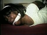 26 YR OLD BLACK BANK TELLER IS HOG-TIED, CLEAVE GAGGED AND HANDGAGGED WHILE STRUGGLING ON THE BED (D52-12)