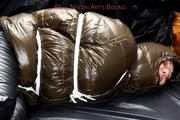 Jill tied and gagged in a shiny nylon down coat