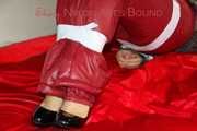 ***NEW MODEL*** Sandra wearing highheels and a sexy red crazy sensation skibib as well as a grey down jacket tied and gagged on a sofa with tape (Pics)