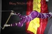 Watching sexy Sonja wearing a supersexy purple shiny nylon rainwear combination being tied and gagged overhead with ropes and a clothgag (Pics)
