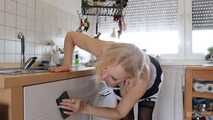 Busty blonde maid Cara cleans the kitchen