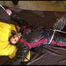 Liz tied and gagged on a bed wearing an oldschool black/red shiny nylon downwear combination (Video)
