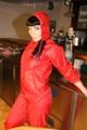 Jill posing in a bar wearing a sexy red rainwear combination with nothing under it (Pics)