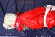 Nina tied and gagged in a shiny red PVC suit