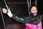 Sexy Mara tied, gagged and hooded overhead on hands and feet with ropes and a cloth gag wearing a sexy black/pink rainwear combination (Pics)